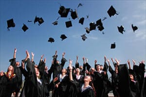 Graduates throwing their caps into the air