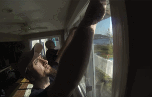 Window film professionals applying window film to home