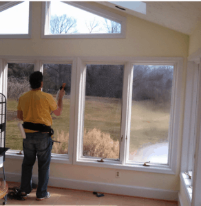 Window film professional applying film to windows