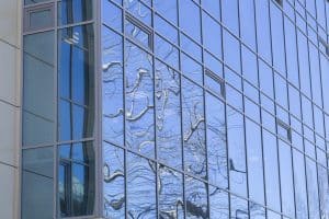 Windows in a commercial office building that are tinted used in the benefits of window film article.